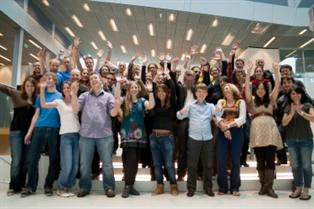 Group of people from a summer school waving at the camera